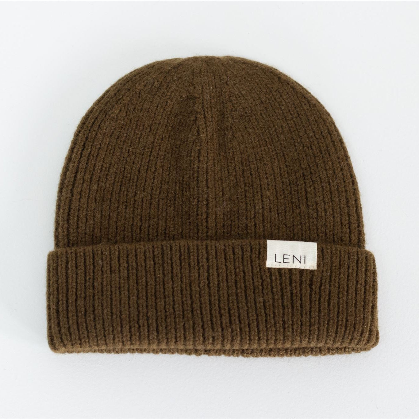 Olive green beanie with a visible brand label on a white background