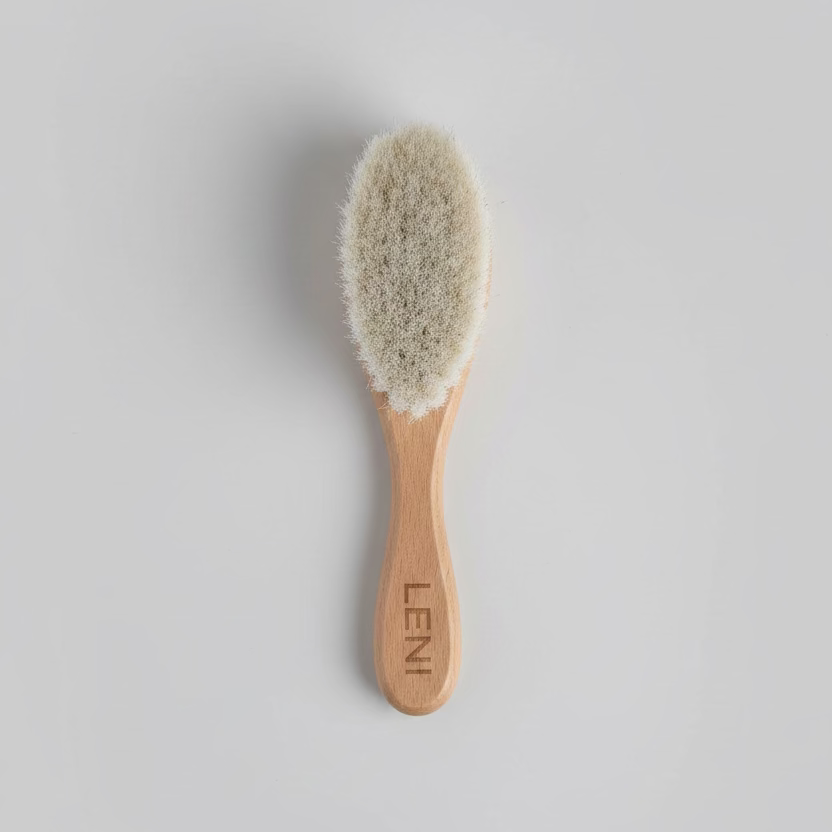 Wooden hairbrush with bristle head on a light gray background, branded 'LENI'.