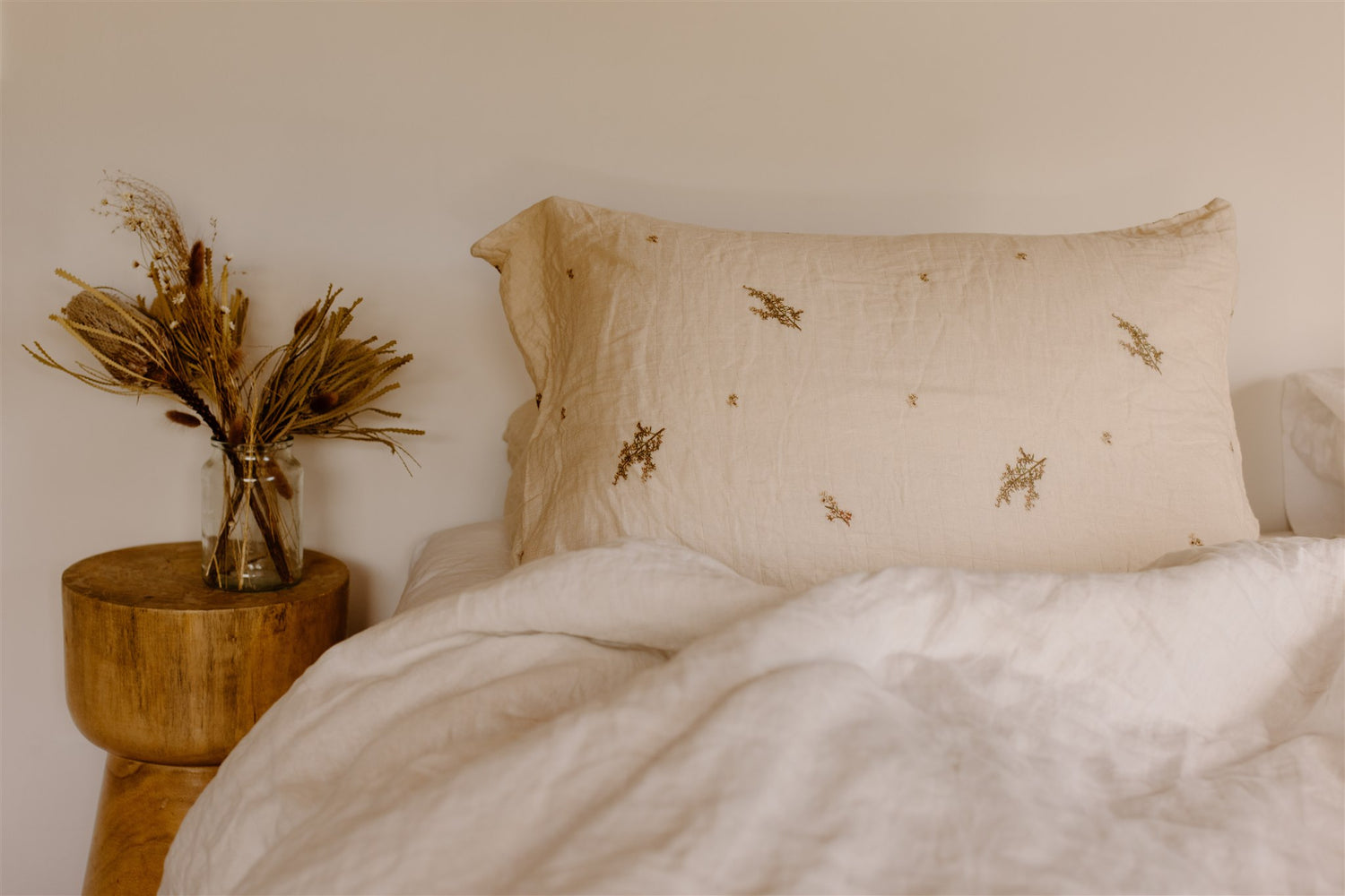 Olive Green Muslin Pillows perched on a stool