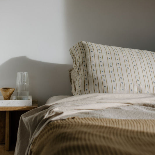 Bedroom with a bed and lamp casting shadows on the wall